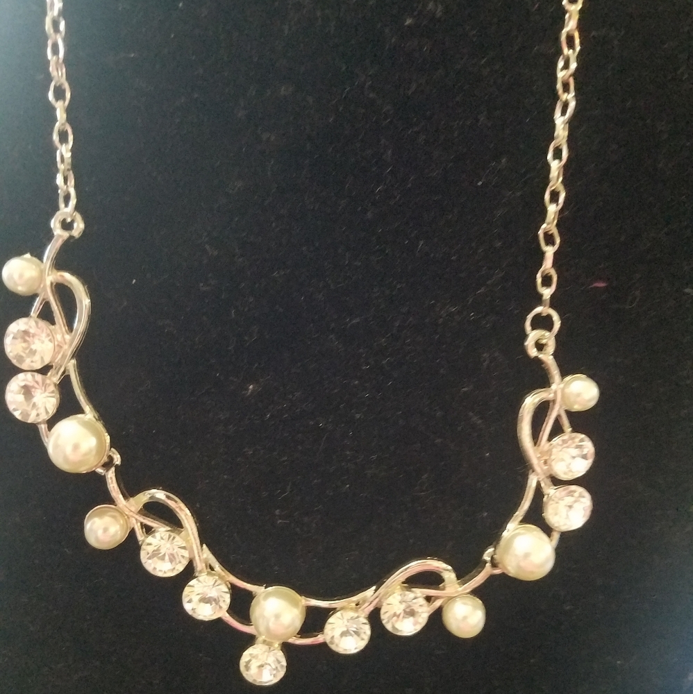 Gold tone necklace with rhinestones.